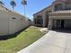 Front yard featuring a well-manicured lawn, a concrete driveway, and a block wall at 1414 N Palmsprings Dr, Gilbert, AZ 85234