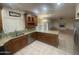 View of an open concept kitchen with tiled floors, granite countertops, and stainless steel appliances at 1414 N Palmsprings Dr, Gilbert, AZ 85234