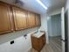 Laundry room with upper cabinets, a utility sink, and modern amenities at 1414 N Palmsprings Dr, Gilbert, AZ 85234