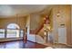 Spacious living room with wood floors, staircase, and large windows overlooking the lake at 1414 N Palmsprings Dr, Gilbert, AZ 85234