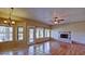 Large living area with wood laminate floors, lake views, and a fireplace at 1414 N Palmsprings Dr, Gilbert, AZ 85234