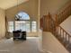Bright living room with large windows offering water views, a staircase, and chandelier at 1414 N Palmsprings Dr, Gilbert, AZ 85234