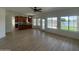 Bright living room featuring stunning lake views through expansive windows and an open flow to the kitchen at 1414 N Palmsprings Dr, Gilbert, AZ 85234