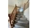 Staircase with carpeted stairs and wooden banisters, leading to the upper levels of the house at 1414 N Palmsprings Dr, Gilbert, AZ 85234