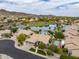 Aerial view of a desert community featuring mature landscaping, a lake, and desert views in the background at 15645 S 17Th St, Phoenix, AZ 85048