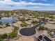 Aerial view of a desert community featuring mature landscaping, a lake, and desert views in the background at 15645 S 17Th St, Phoenix, AZ 85048