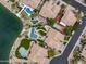 Aerial view shows an estate with lush landscaping, multiple pools, a lake, and a putting green at 15645 S 17Th St, Phoenix, AZ 85048