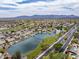 Scenic aerial view showcasing a community with a lake, golf course, and mountain views in the background at 15645 S 17Th St, Phoenix, AZ 85048