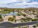 Aerial view of a desert community featuring mature landscaping, a lake, and desert views in the background at 15645 S 17Th St, Phoenix, AZ 85048