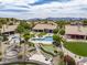 Aerial view of an upscale backyard with a pool, putting green, patio, and beautiful landscaping at 15645 S 17Th St, Phoenix, AZ 85048