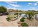 This backyard boasts a putting green, lake view, and stone patio at 15645 S 17Th St, Phoenix, AZ 85048
