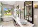 Bathroom featuring dual sinks, soaking tub and large windows with a great view at 15645 S 17Th St, Phoenix, AZ 85048
