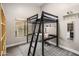 This bedroom features a loft bed and desk and a gray patterned rug at 15645 S 17Th St, Phoenix, AZ 85048