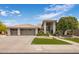 This home features a three-car garage, desert landscaping, and a tile roof at 15645 S 17Th St, Phoenix, AZ 85048