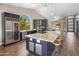 Modern kitchen with stainless steel appliances, a spacious island, and bright, vaulted ceilings at 15645 S 17Th St, Phoenix, AZ 85048