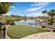This lake view shows a putting green and multiple homes at 15645 S 17Th St, Phoenix, AZ 85048