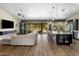 Open-concept living room featuring a long island, gray couch, and sliding glass doors to the backyard at 15645 S 17Th St, Phoenix, AZ 85048