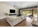 Bright living room with a vaulted ceiling, large sectional sofa, and view of the lush backyard at 15645 S 17Th St, Phoenix, AZ 85048