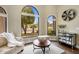 This cozy living room features hardwood floors and arched windows at 15645 S 17Th St, Phoenix, AZ 85048
