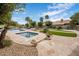 Beautiful backyard oasis featuring a sparkling pool, relaxing spa, and lush landscaping with palm trees at 15645 S 17Th St, Phoenix, AZ 85048