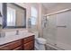 Bathroom featuring a glass shower, a window with blinds, and a vanity with stylish fixtures at 16445 W Berkeley Rd, Goodyear, AZ 85395