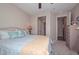 Comfortable bedroom boasts neutral colors, plush carpet, and convenient access to an ensuite bathroom at 16445 W Berkeley Rd, Goodyear, AZ 85395