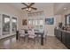 Stylish dining area with large windows, a modern ceiling fan, and a convenient bar area at 16445 W Berkeley Rd, Goodyear, AZ 85395