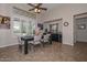 Bright dining area featuring neutral walls, a modern ceiling fan, and convenient bar area at 16445 W Berkeley Rd, Goodyear, AZ 85395