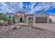 Charming stucco home featuring a tile roof, desert landscaping, and a spacious three-car garage at 16445 W Berkeley Rd, Goodyear, AZ 85395