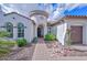 Inviting front entrance with arched doorway and manicured landscaping, leading to a beautiful home at 16445 W Berkeley Rd, Goodyear, AZ 85395