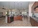Gourmet kitchen with granite countertops, custom cabinetry, and an open design to the living area at 16445 W Berkeley Rd, Goodyear, AZ 85395