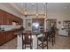 A spacious open kitchen featuring a central island, pendant lighting and a dining space at 16445 W Berkeley Rd, Goodyear, AZ 85395