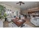 Open-concept living room with plantation shutters and seamless flow to the kitchen area at 16445 W Berkeley Rd, Goodyear, AZ 85395