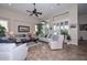 Spacious living room with high ceilings, plantation shutters, and comfortable seating arrangements at 16445 W Berkeley Rd, Goodyear, AZ 85395