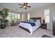 Bright main bedroom with large windows, plantation shutters, and neutral decor at 16445 W Berkeley Rd, Goodyear, AZ 85395
