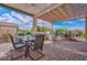 Spacious covered patio features a dining area, a built-in BBQ, and a water feature at 16445 W Berkeley Rd, Goodyear, AZ 85395