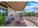 Inviting outdoor space with a cozy seating area, fire pit, and built-in grill, ideal for relaxation at 16445 W Berkeley Rd, Goodyear, AZ 85395