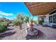 Secluded patio boasts a fountain, fire pit, seating area, and meticulous landscaping for outdoor enjoyment at 16445 W Berkeley Rd, Goodyear, AZ 85395