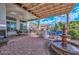 Expansive brick patio features ample seating, a fountain, and outdoor dining space, perfect for entertaining at 16445 W Berkeley Rd, Goodyear, AZ 85395