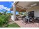 Inviting covered patio features a dining area, built-in grill, and beautifully landscaped yard at 16445 W Berkeley Rd, Goodyear, AZ 85395