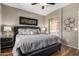 Bedroom featuring a large bed, wood-look flooring, and an ensuite bathroom at 16626 E Westby Dr # 108, Fountain Hills, AZ 85268