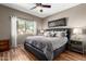 Bedroom with a large window, ceiling fan, and dark wood-look flooring at 16626 E Westby Dr # 108, Fountain Hills, AZ 85268