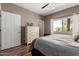 Bedroom with wood-look flooring and a large window for natural light at 16626 E Westby Dr # 108, Fountain Hills, AZ 85268