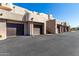 Exterior view of garages with brown doors and cactus landscaping with staircases at 16626 E Westby Dr # 108, Fountain Hills, AZ 85268