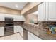 Kitchen with stainless steel appliances, mosaic backsplash, and granite countertops at 16626 E Westby Dr # 108, Fountain Hills, AZ 85268