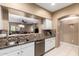 Open kitchen with stainless steel dishwasher and view to the adjacent living room at 16626 E Westby Dr # 108, Fountain Hills, AZ 85268
