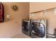 Laundry room featuring modern washer and dryer sets with wall decoration and shelving at 16626 E Westby Dr # 108, Fountain Hills, AZ 85268