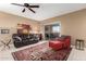 Comfortable living room with a plush leather sofa, red ottoman, and stylish decor at 16626 E Westby Dr # 108, Fountain Hills, AZ 85268