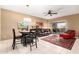 Inviting living room with a sliding glass door, modern ceiling fan, and a dining table set at 16626 E Westby Dr # 108, Fountain Hills, AZ 85268