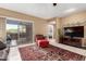 Bright living room with balcony access, comfortable seating, and a decorative TV at 16626 E Westby Dr # 108, Fountain Hills, AZ 85268